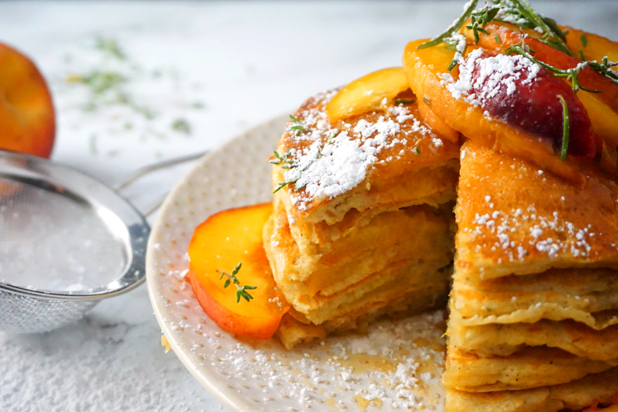 fluffy buttermilk peach pancakes topped with rosemary peach sauce and pure maple syrup