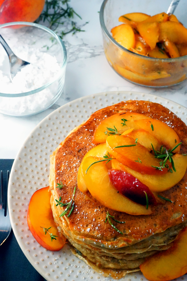 fluffy buttermilk peach pancakes topped with rosemary peach sauce and pure maple syrup