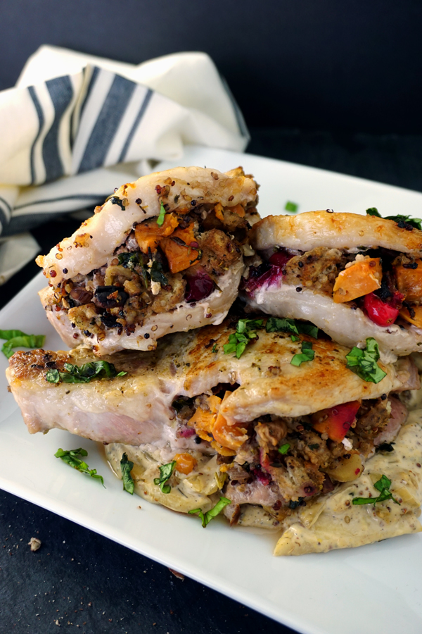 Stuffed Pork Chops on a plate with creamy mustard sauce