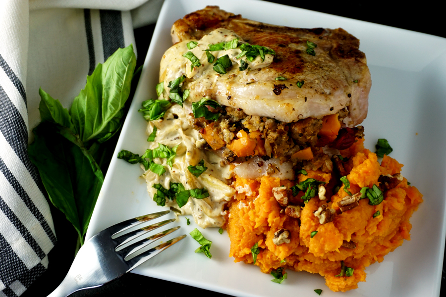 Stuffed Pork Chops on a plate with creamy mustard sauce