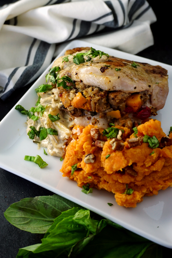 Stuffed Pork Chops on a plate with creamy mustard sauce