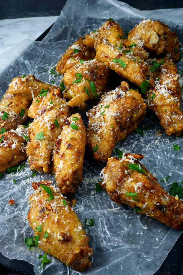 parmesan truffle chicken wings on a baking pan with wax paper