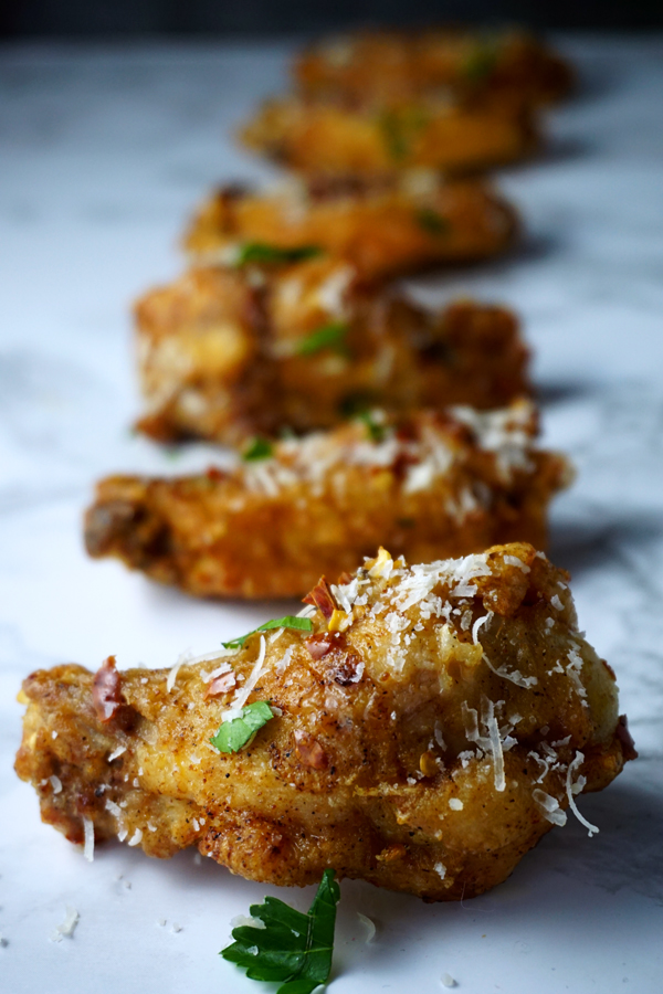 parmesan truffle chicken wings close up sprinkled with parsley