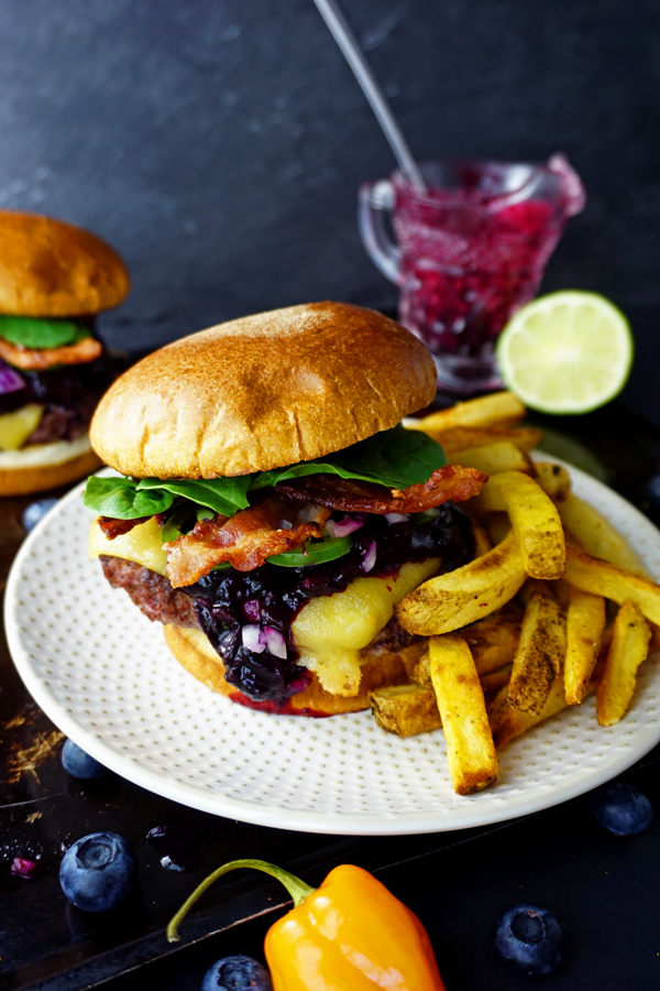 Habanero-lime blueberry compote tops two juicy bacon cheeseburgers with a side of fries