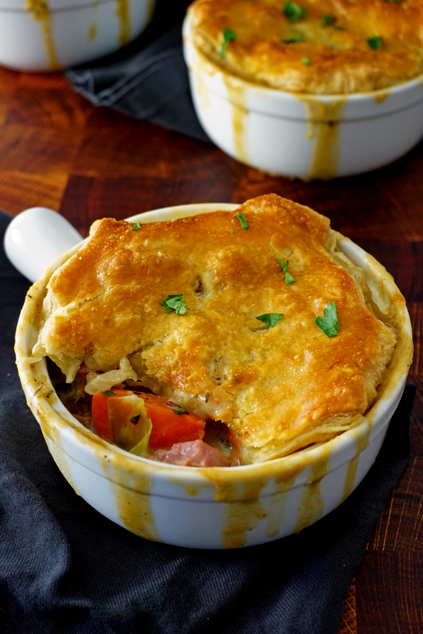 A close up of a corned beef pot pie with a bite missing