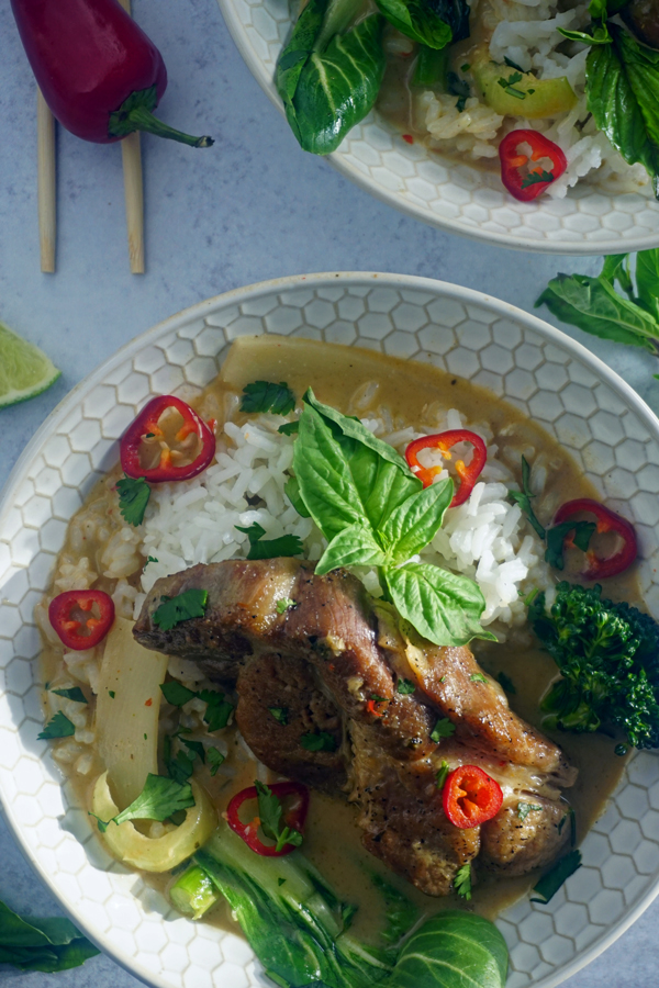 Thai curry made with coconut milk and galangal with braised pork ribs, rice and garnished with Thai basil