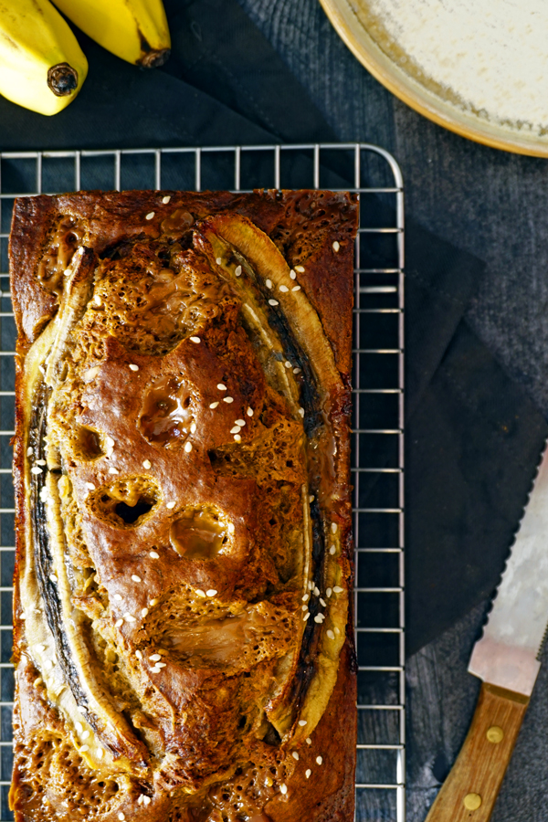 fresh baked coconut banana bread on a wire cooling rack