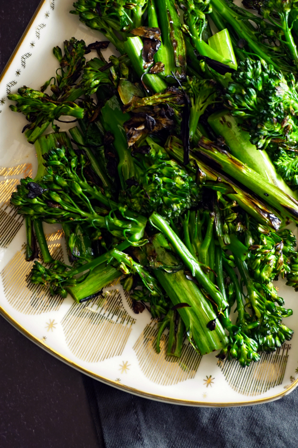 stovetop charred broccolini on a metallic plate