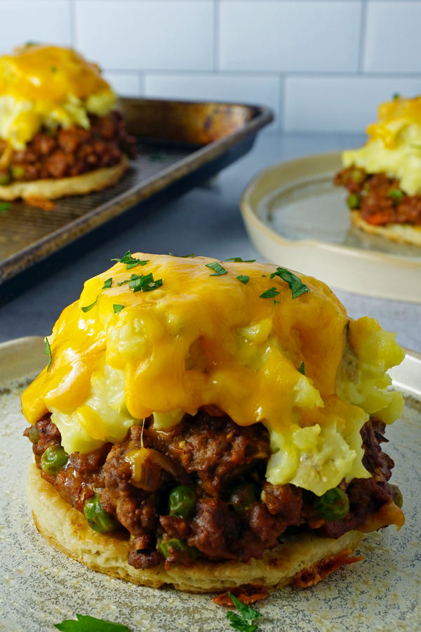 a close-up image on an individual shepherd's pie (cottage pie) on a pie crust round topped with melted cheese